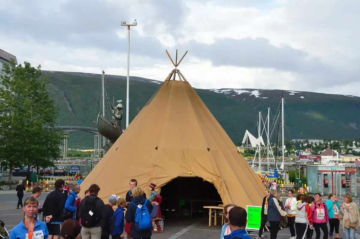 A large Sámi lavvu tent pitched by the harbour in Tromsø, the tent type used at camps on Tromso reindeer sledding tours